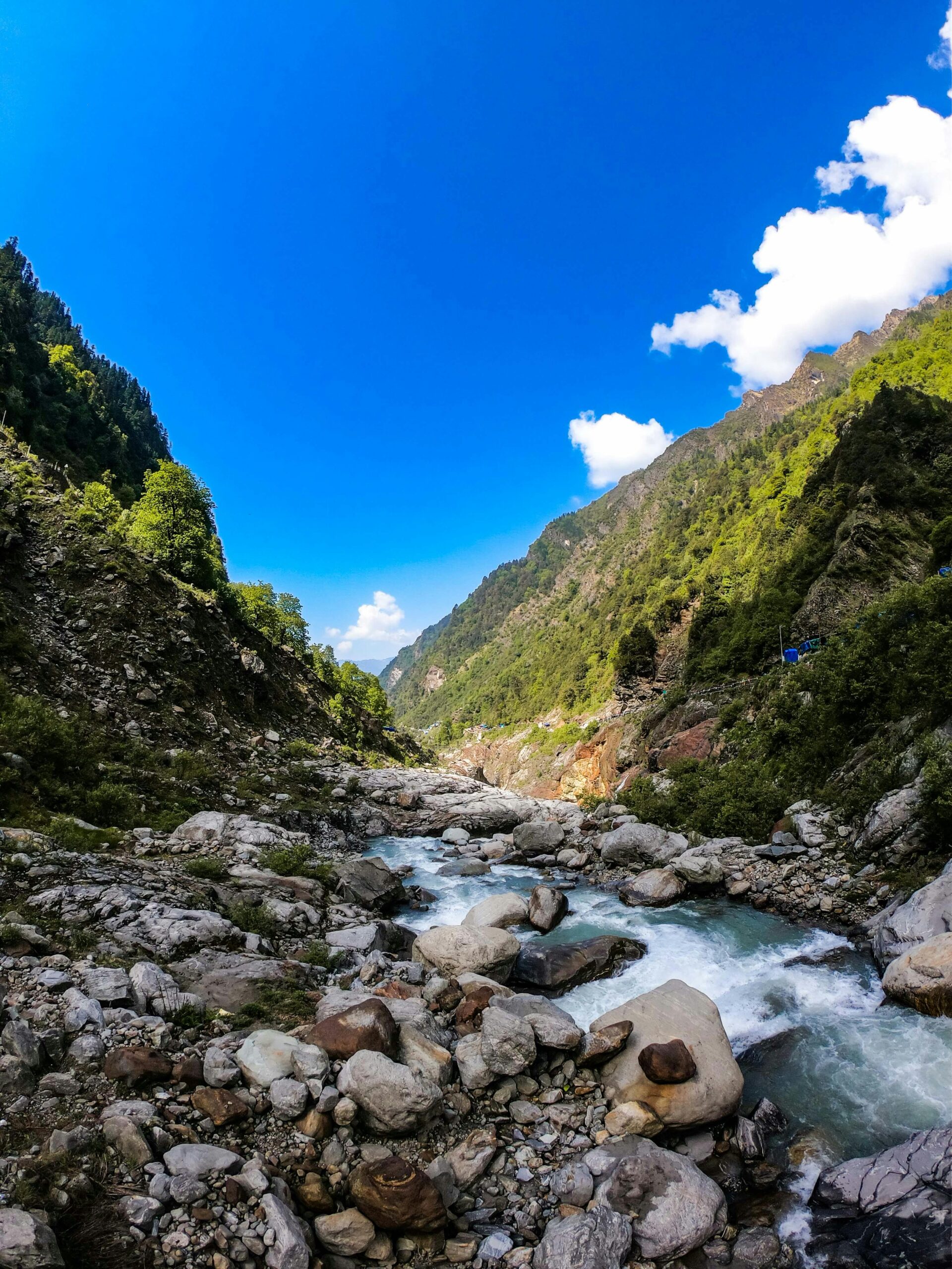 pexels-photo-12369018-12369018 Explore the breathtaking river landscape in the Kedarnath Valley, India under a vibrant blue sky.